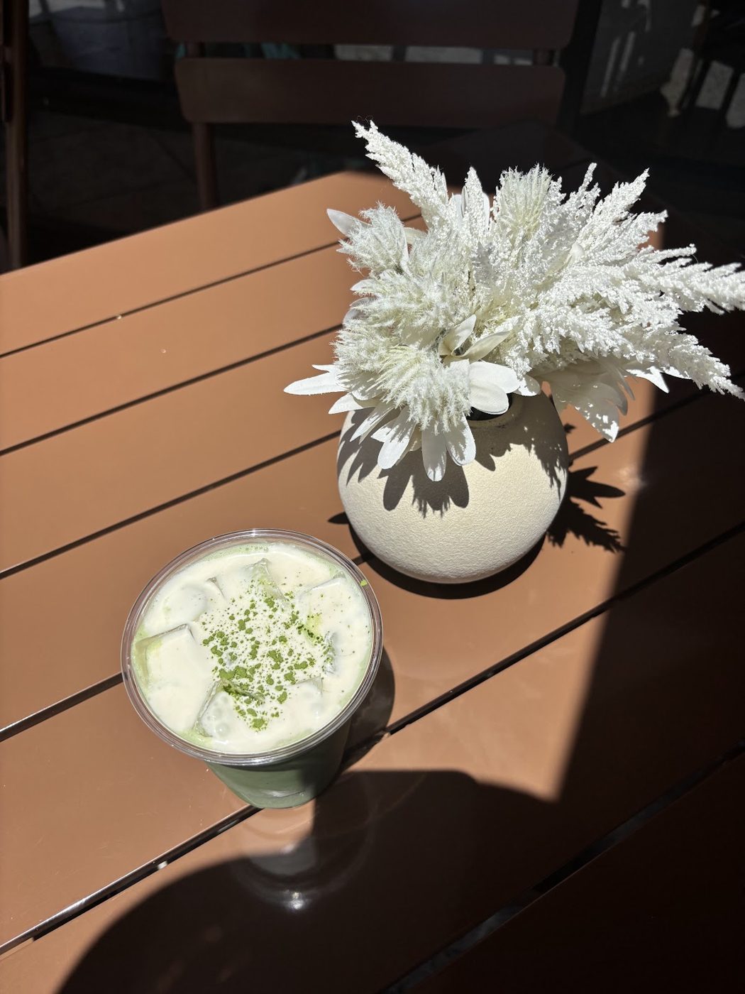 Iced matcha on a marble table by the window