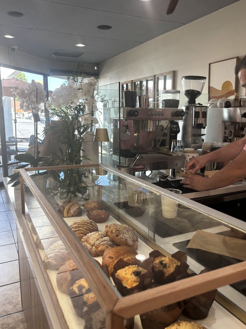The pastry case with croissants and muffins