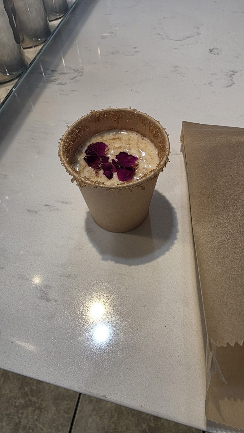 Saffron rose latte with cold foam and dried rose petals