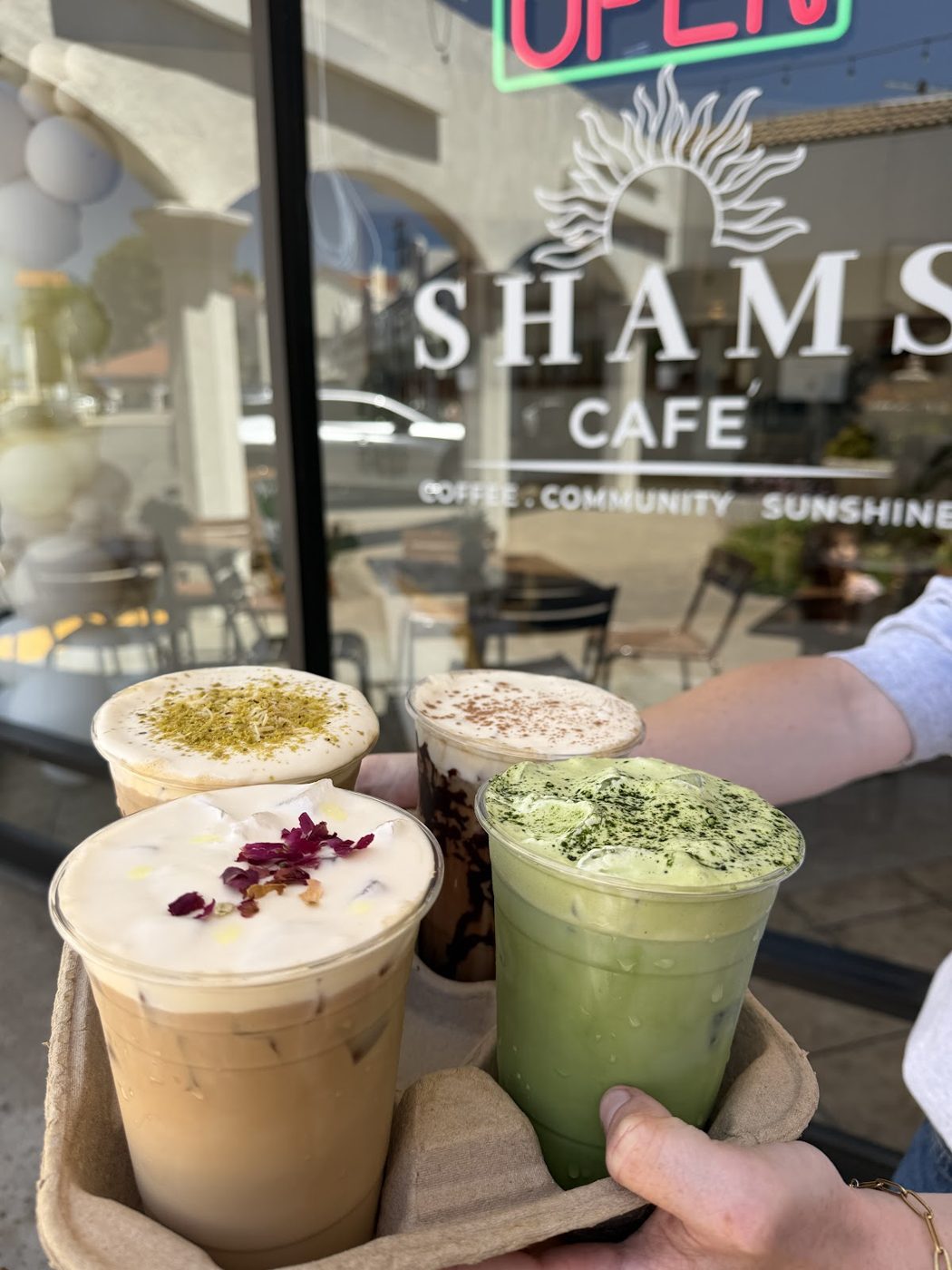 Shams Cafe storefront sign: Coffee, Community, Sunshine